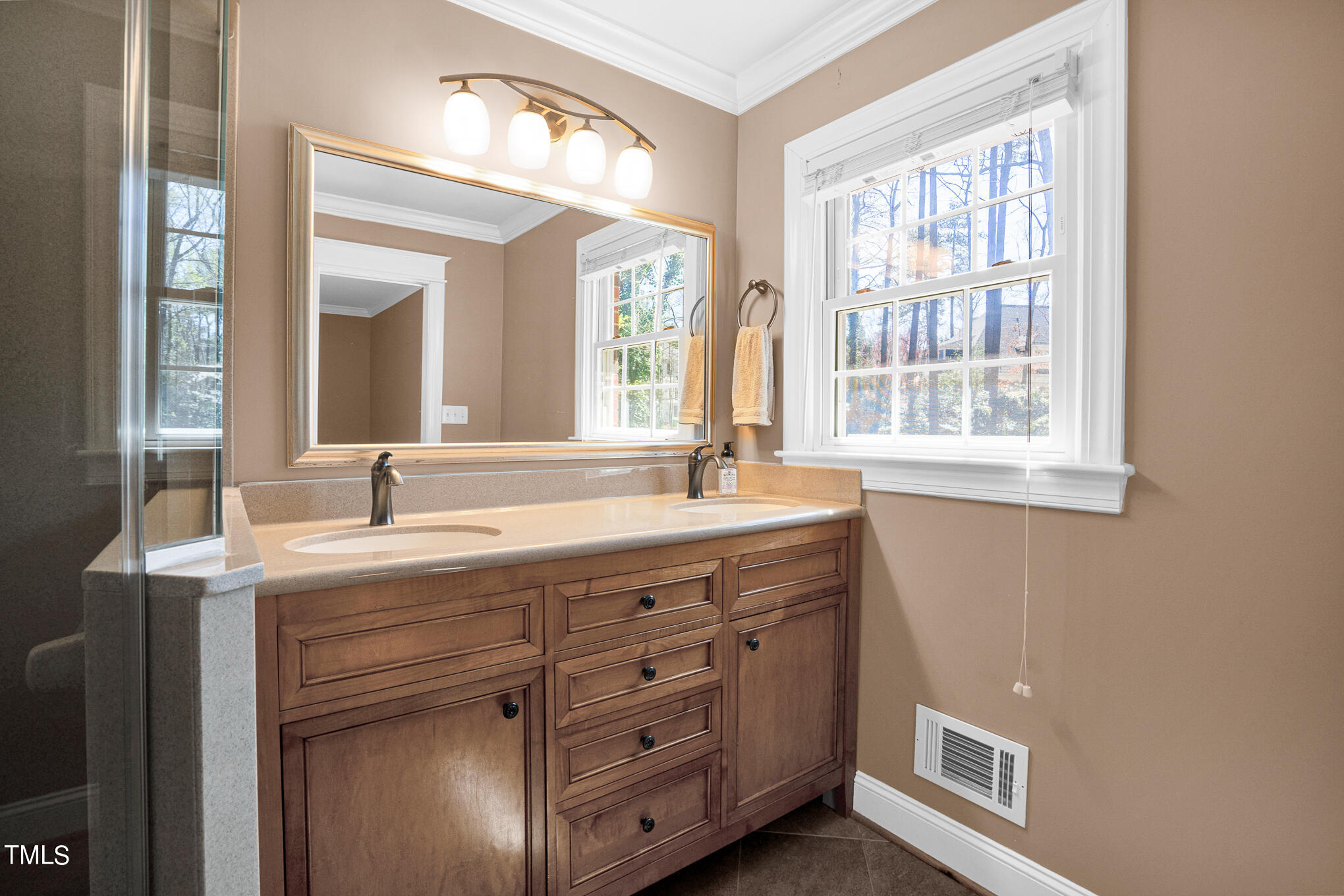 4501 Boxwood Road Raleigh, NC 27612 - Photo 32 of 44 a bathroom with a granite countertop sink a large mirror and a window