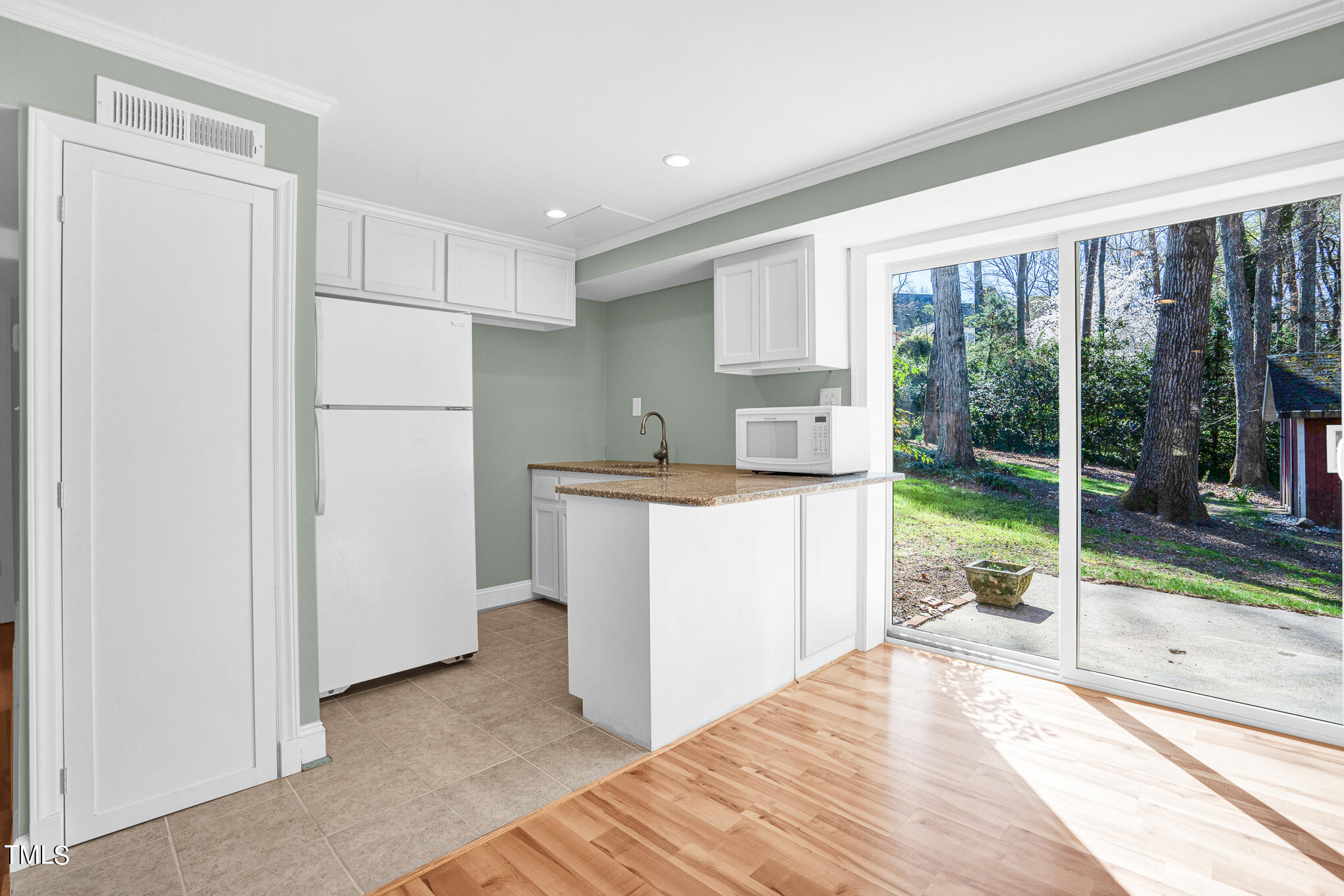 4501 Boxwood Road Raleigh, NC 27612 - Photo 35 of 44 a kitchen with a refrigerator and a sink