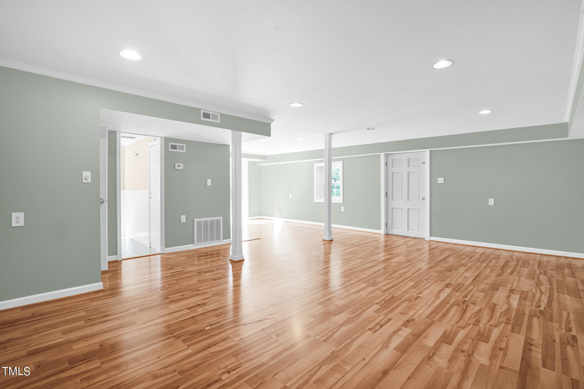 4501 Boxwood Road Raleigh, NC 27612 - Photo 40 of 44 a view of an empty room with wooden floor