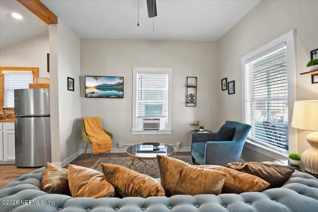 a living room with furniture a rug and a window