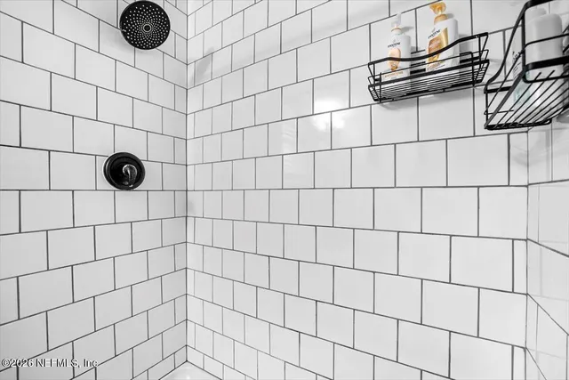 a bedroom with a bed and a flat tv screen on dresser