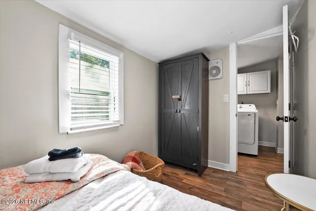 a bedroom with a bed and a window