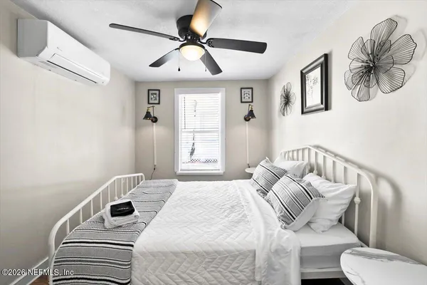 a bedroom with a bed and a chandelier