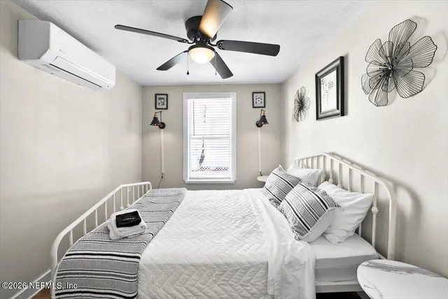 a bedroom with a bed and a chandelier