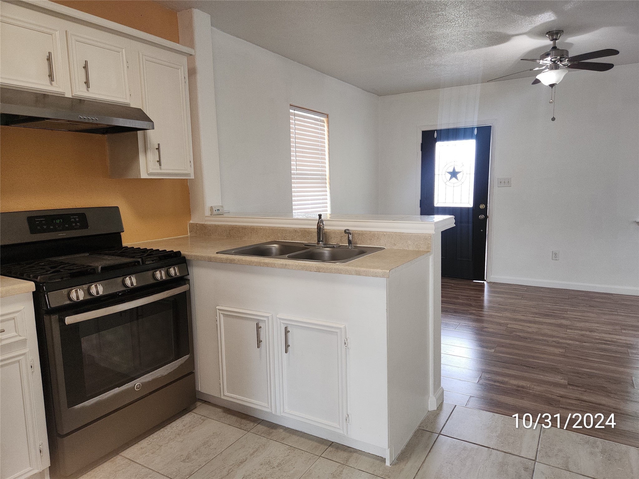 703 North Avenue B Freeport, TX 77541 - Photo 11 of 14 a kitchen with granite countertop a stove and a sink