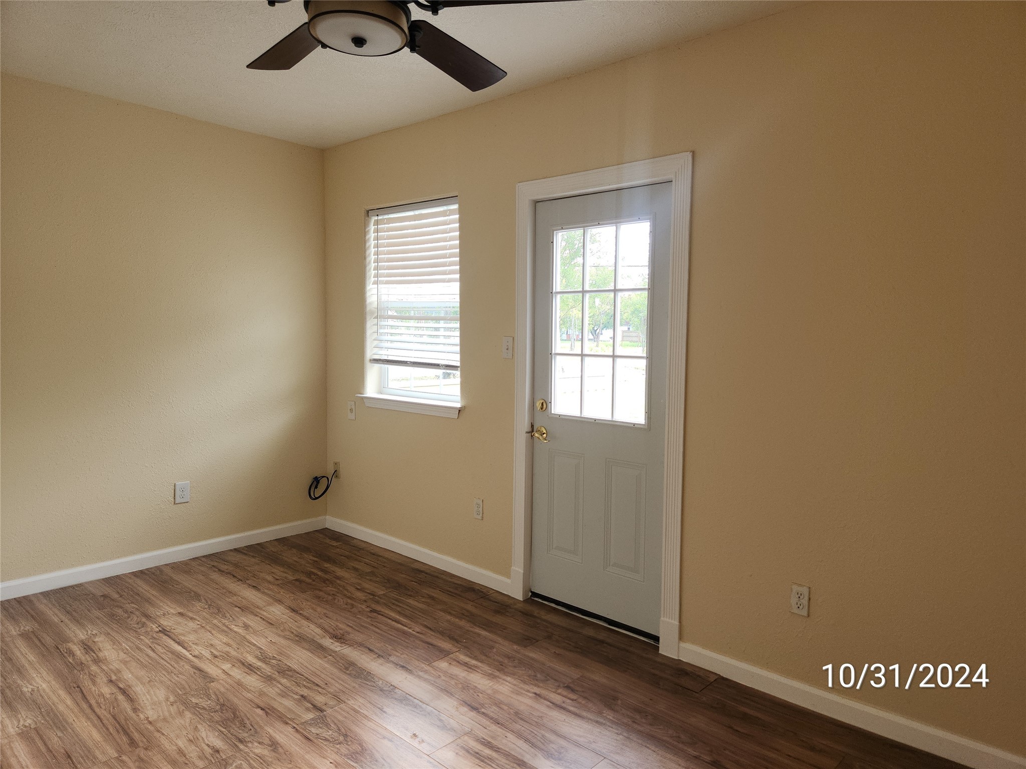703 North Avenue B Freeport, TX 77541 - Photo 13 of 14 an empty room with wooden floor cabinet and windows