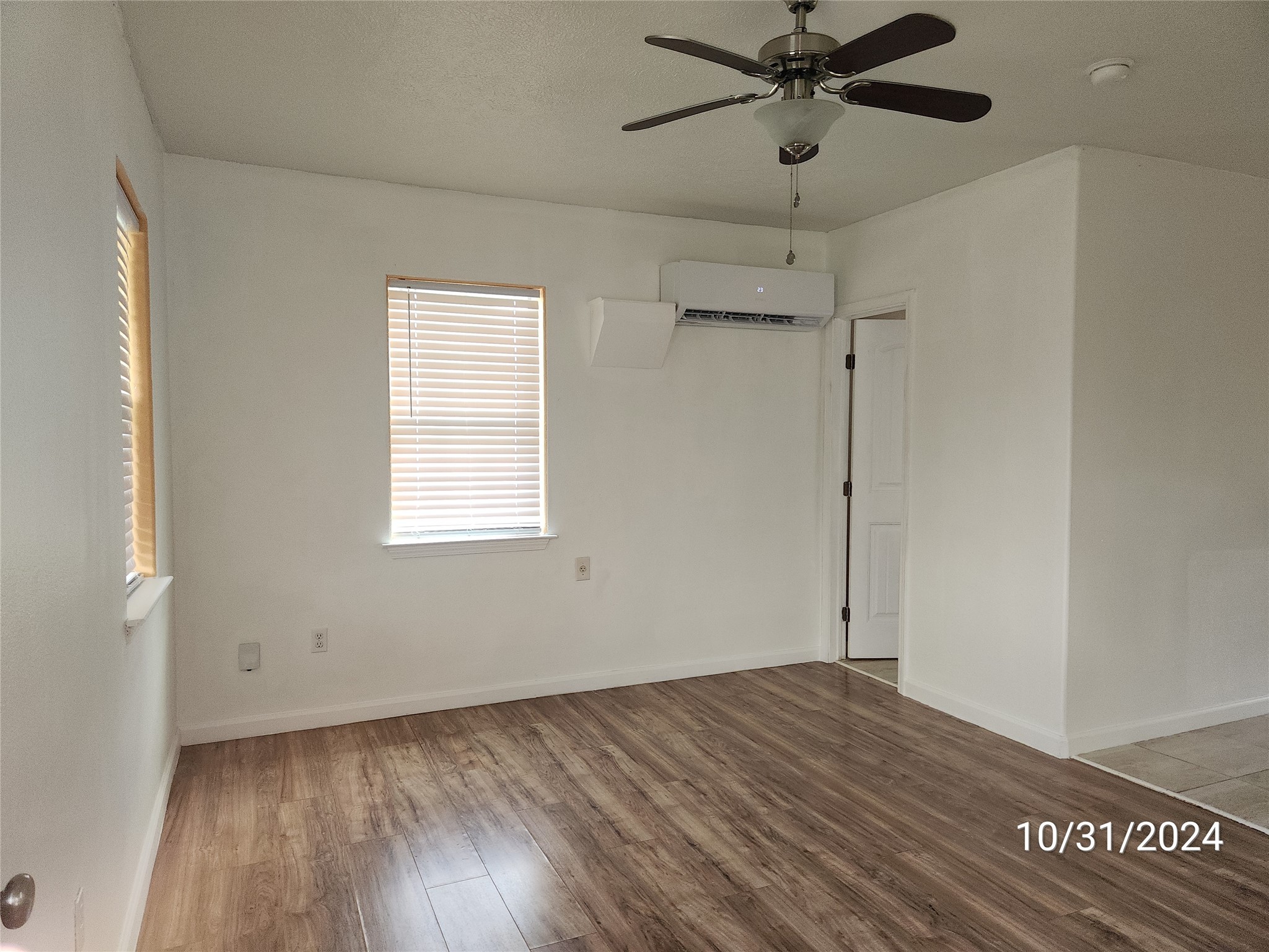 703 North Avenue B Freeport, TX 77541 - Photo 2 of 14 a view of a room with wooden floor and a ceiling fan
