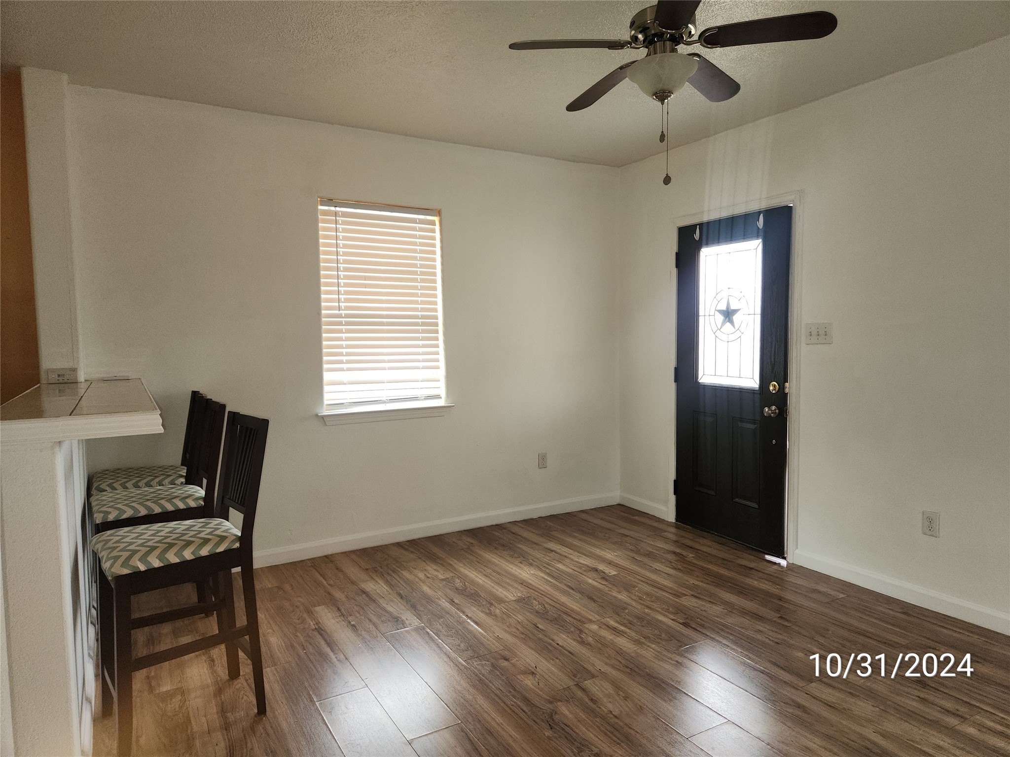 703 North Avenue B Freeport, TX 77541 - Photo 5 of 14 a view of room with a window and wooden floor