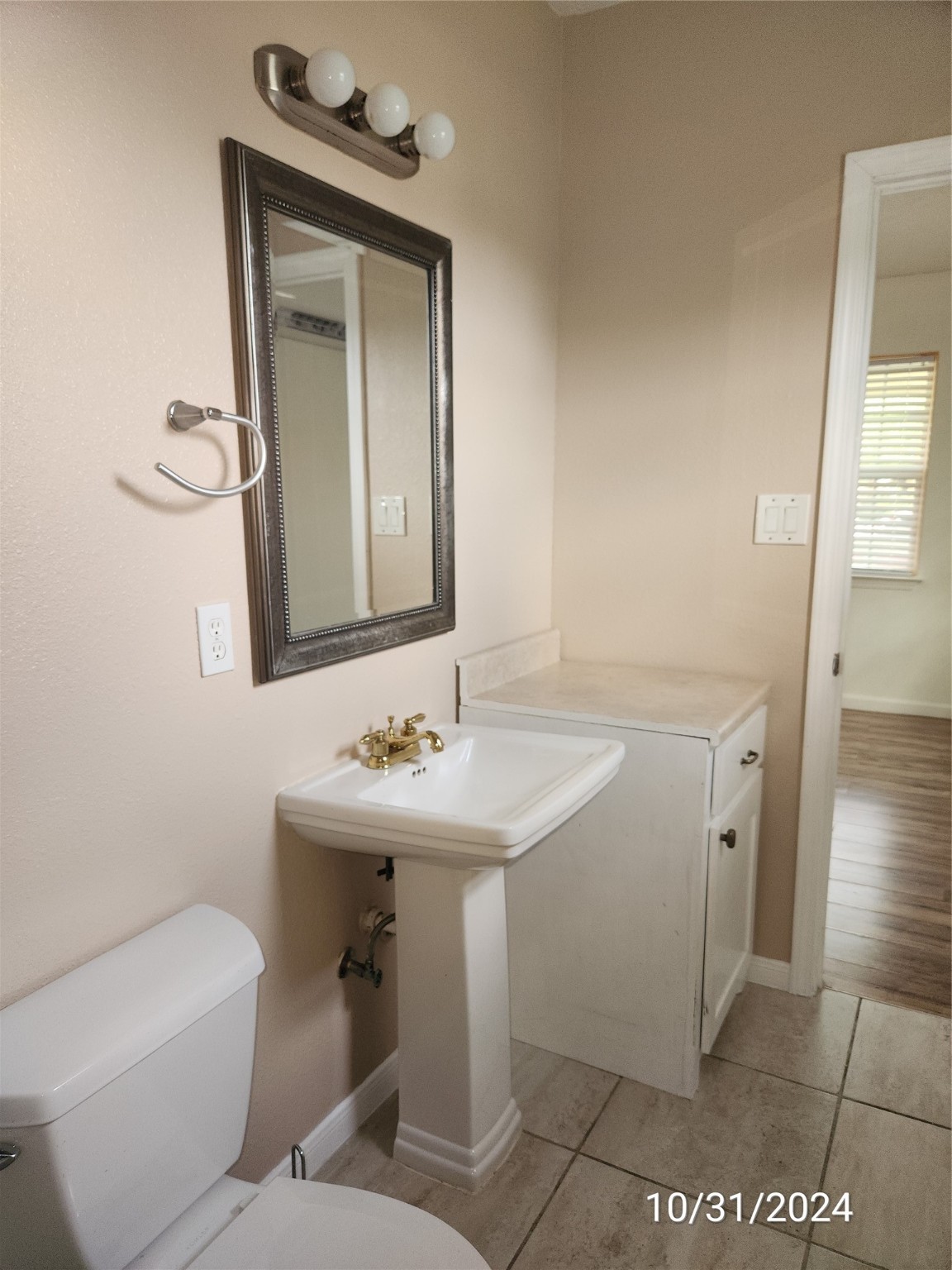 703 North Avenue B Freeport, TX 77541 - Photo 7 of 14 a bathroom with a toilet a sink and mirror