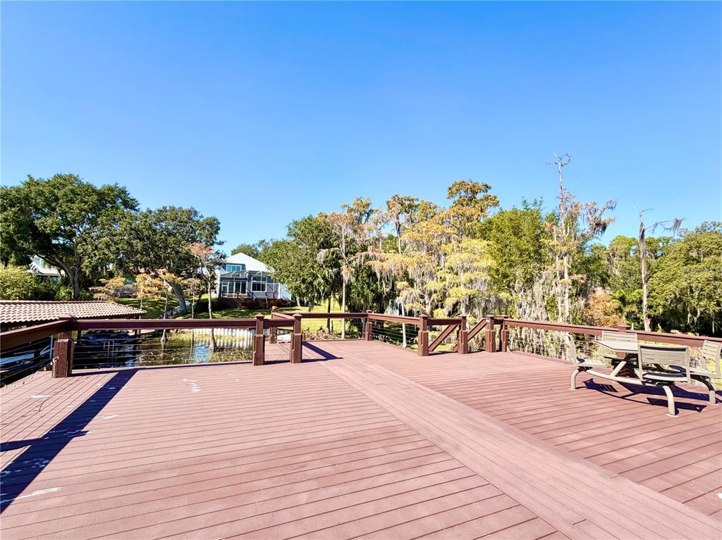 5243 West Lake Butler Road Windermere, FL 34786 - Photo 39 of 43 a park with wooden benches and trees in the background