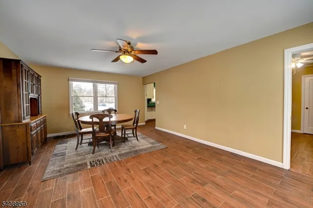 a view of a dining room with furniture and a window