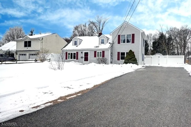 a view of a house with snow on the road