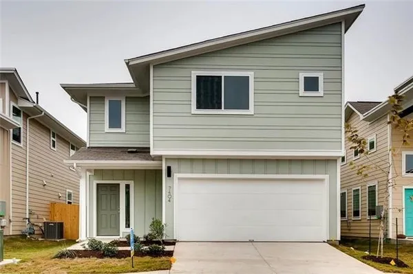 a front view of a house with a garage