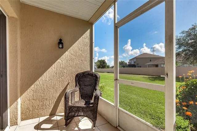 a view of a chair and tables in the balcony
