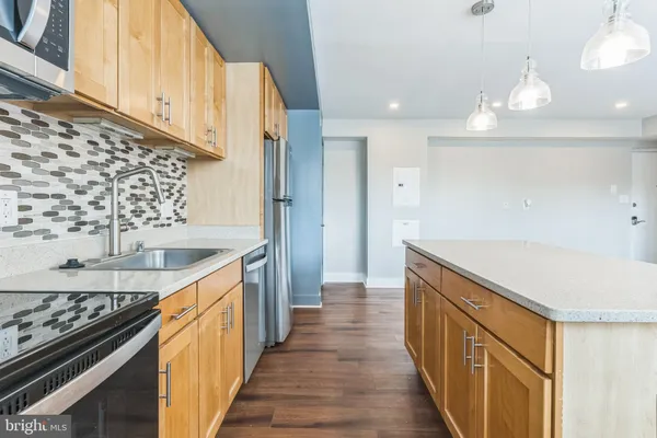 a kitchen with granite countertop a sink and a stove