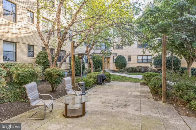 a view of a patio with couches table and chairs and potted plants