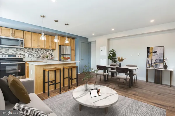 a living room with furniture and a dining table