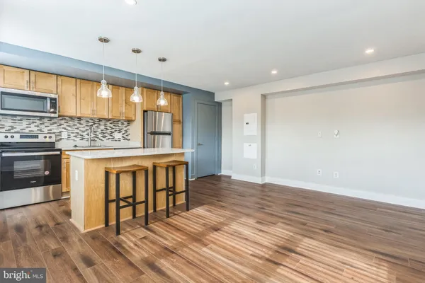 a view of kitchen with furniture and wooden floor