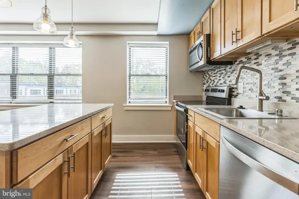 a kitchen with granite countertop a sink and a window