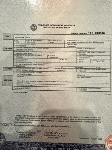 a front view of a house with a yard and a garage