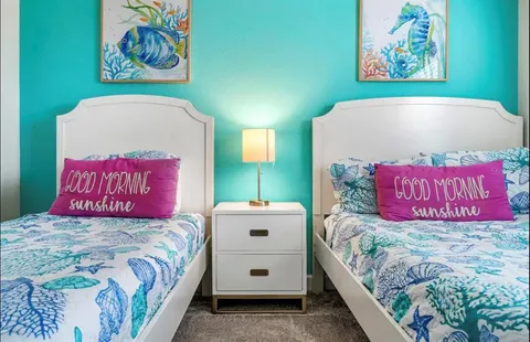 a bedroom with a bed and a painting on the wall