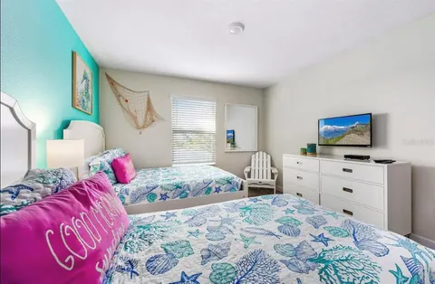 a bedroom with a bed and dresser with mirror