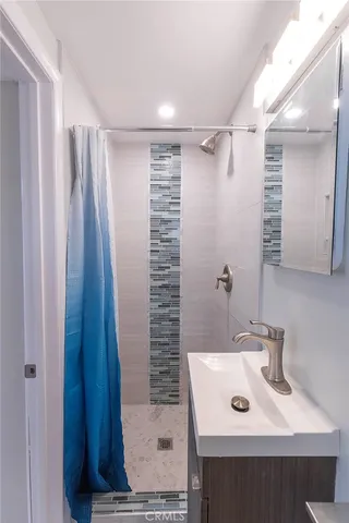 a bathroom with a sink a toilet a mirror and vanity