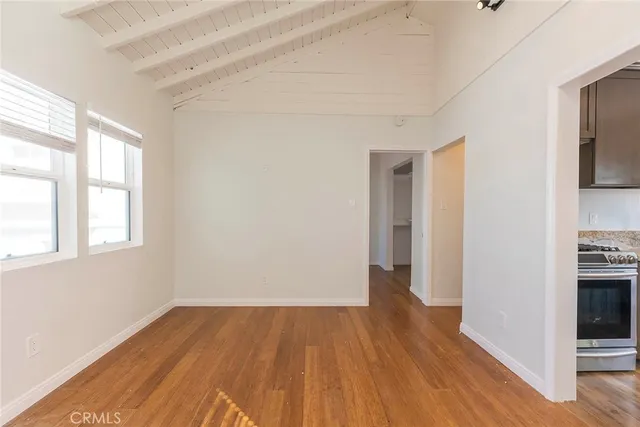 a view of a room with wooden floor and a window