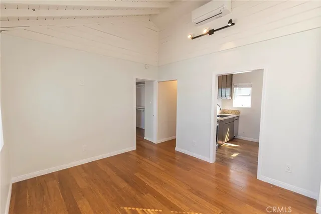 a view of a kitchen and a sink with wooden floor