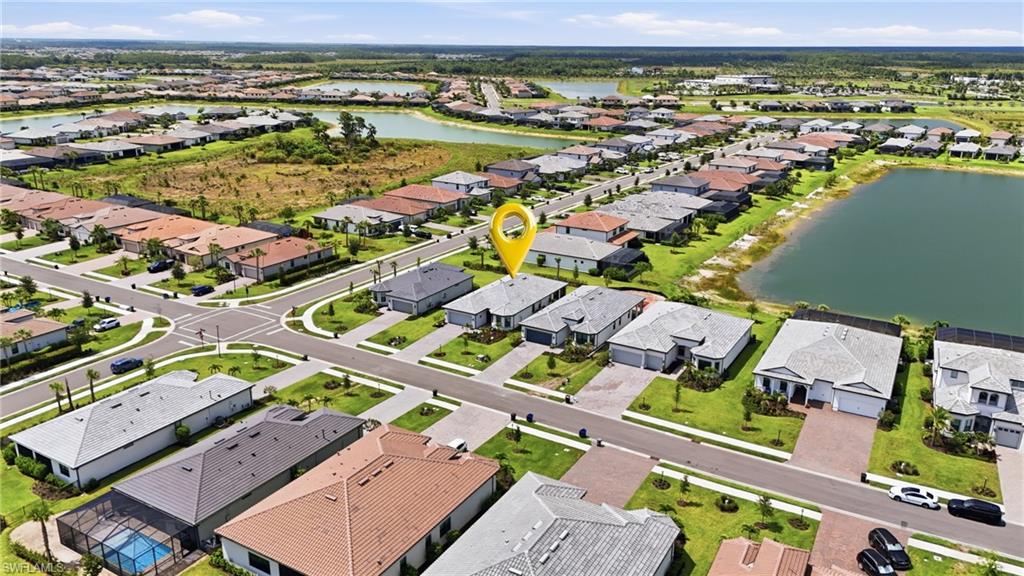 18364 Ridgeline Drive Estero, FL 33928 - Photo 7 of 50 an aerial view of a city with lots of residential buildings and ocean view
