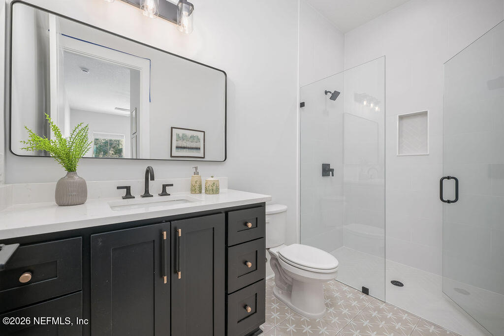 2747 Anchor Road Middleburg, FL 32068 - Photo 16 of 26 a bathroom with a granite countertop sink a toilet and a mirror