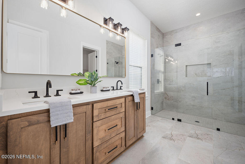 2747 Anchor Road Middleburg, FL 32068 - Photo 20 of 26 a spacious bathroom with a granite countertop sink mirror and shower