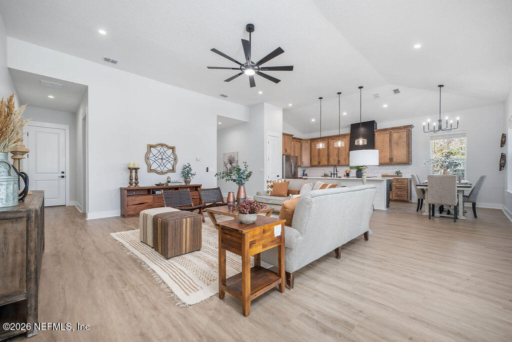 2747 Anchor Road Middleburg, FL 32068 - Photo 9 of 26 a living room with furniture kitchen view and a wooden floor