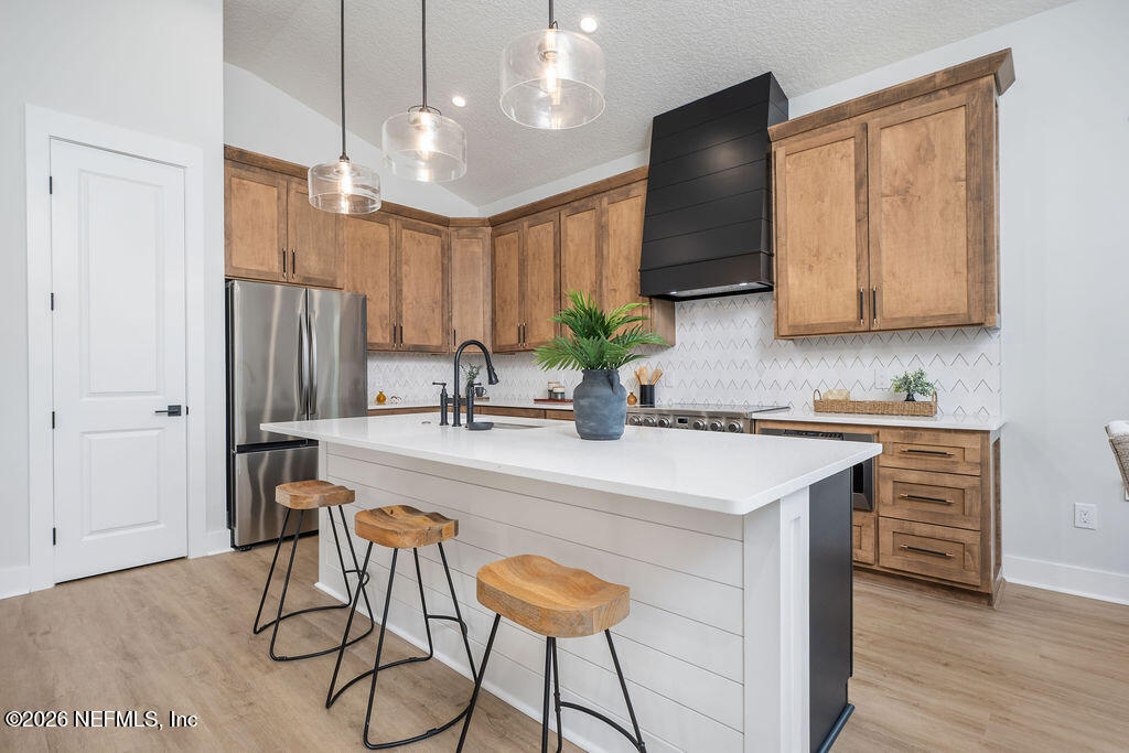 2747 Anchor Road Middleburg, FL 32068 - Photo 10 of 26 a kitchen with stainless steel appliances granite countertop a sink a stove a refrigerator and island with wooden floor
