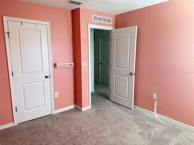 an empty room with closet area