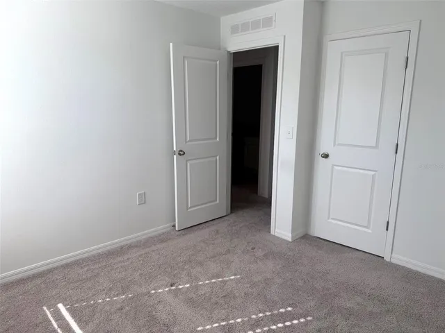 a view of an empty room and closet area