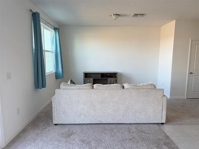 a living room with a couch and a window