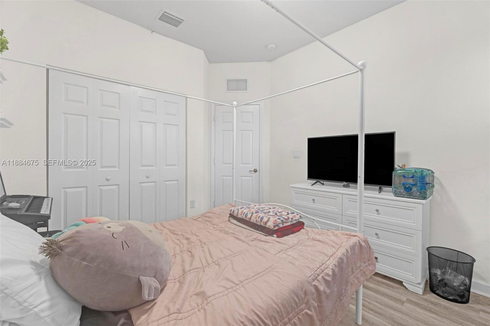 11413 Southwest 253rd Street, Unit 11413 Homestead, FL 33032 - Photo 16 of 44 a bedroom with a bed and a flat screen tv