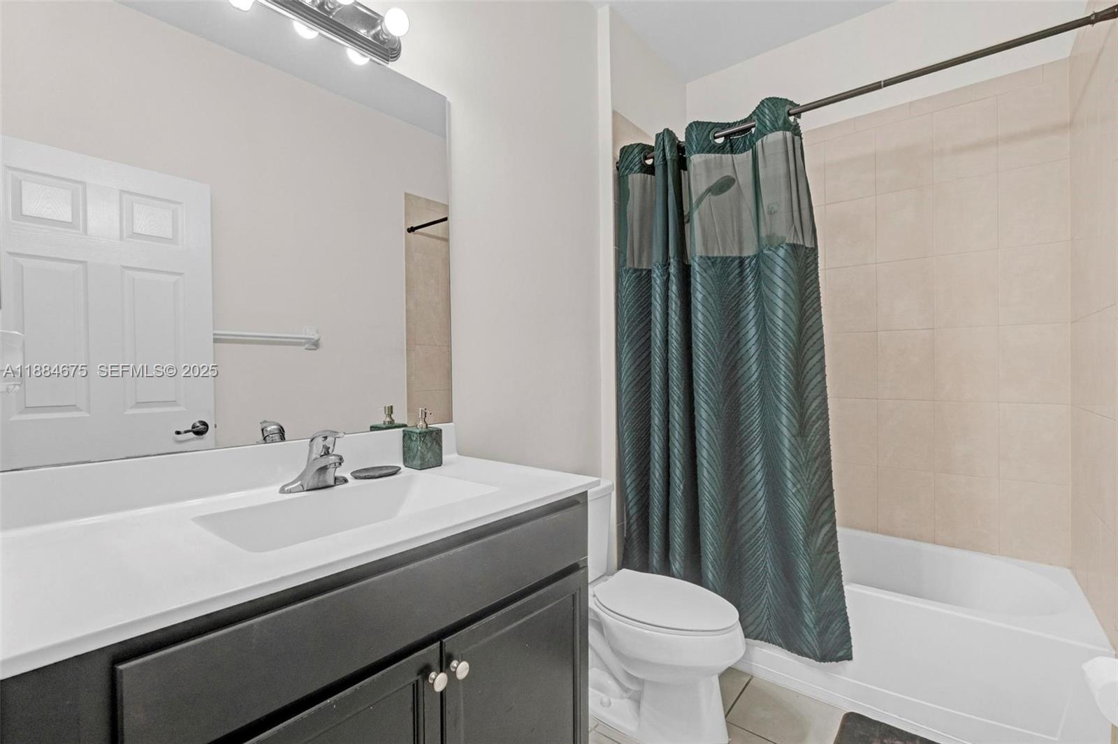 11413 Southwest 253rd Street, Unit 11413 Homestead, FL 33032 - Photo 17 of 44 a bathroom with a sink a toilet a mirror and shower