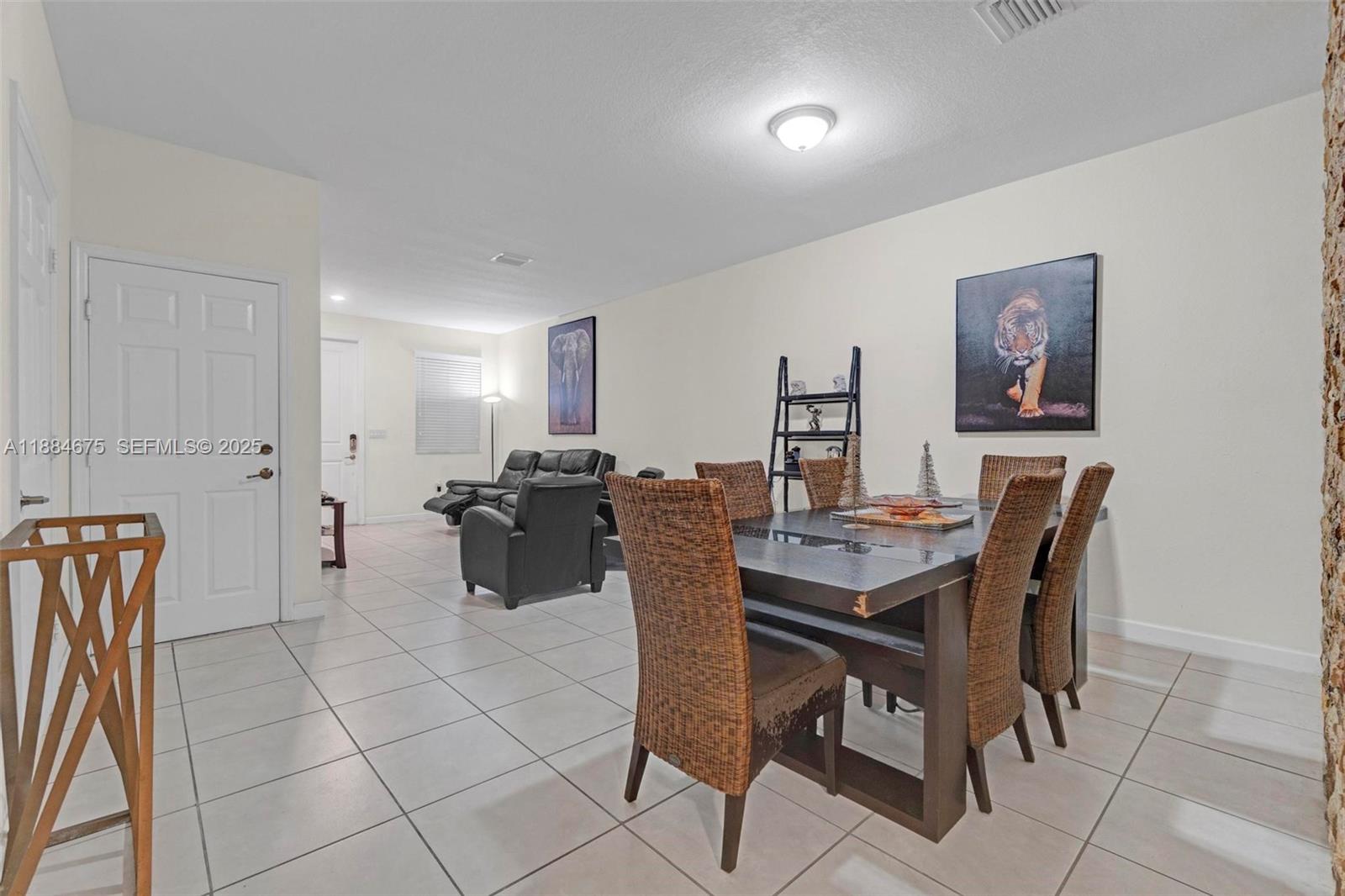 11413 Southwest 253rd Street, Unit 11413 Homestead, FL 33032 - Photo 19 of 44 a view of a dining room with furniture