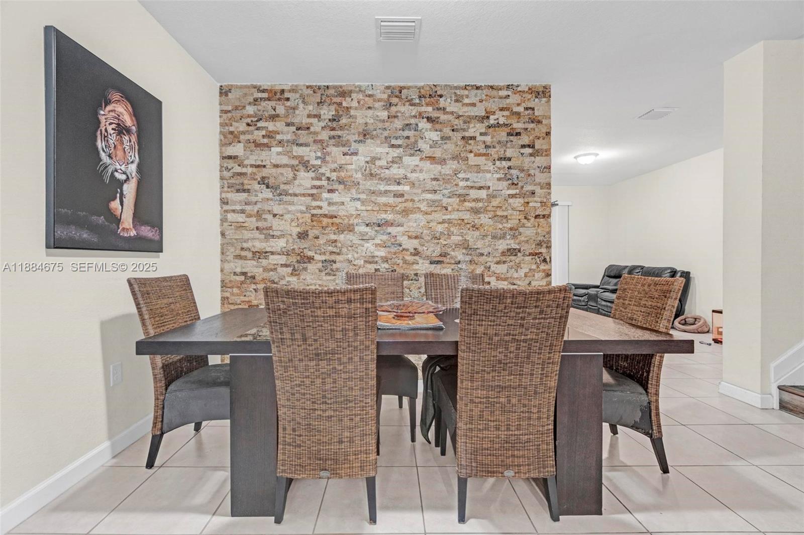 11413 Southwest 253rd Street, Unit 11413 Homestead, FL 33032 - Photo 22 of 44 a brick wall with a table and chairs