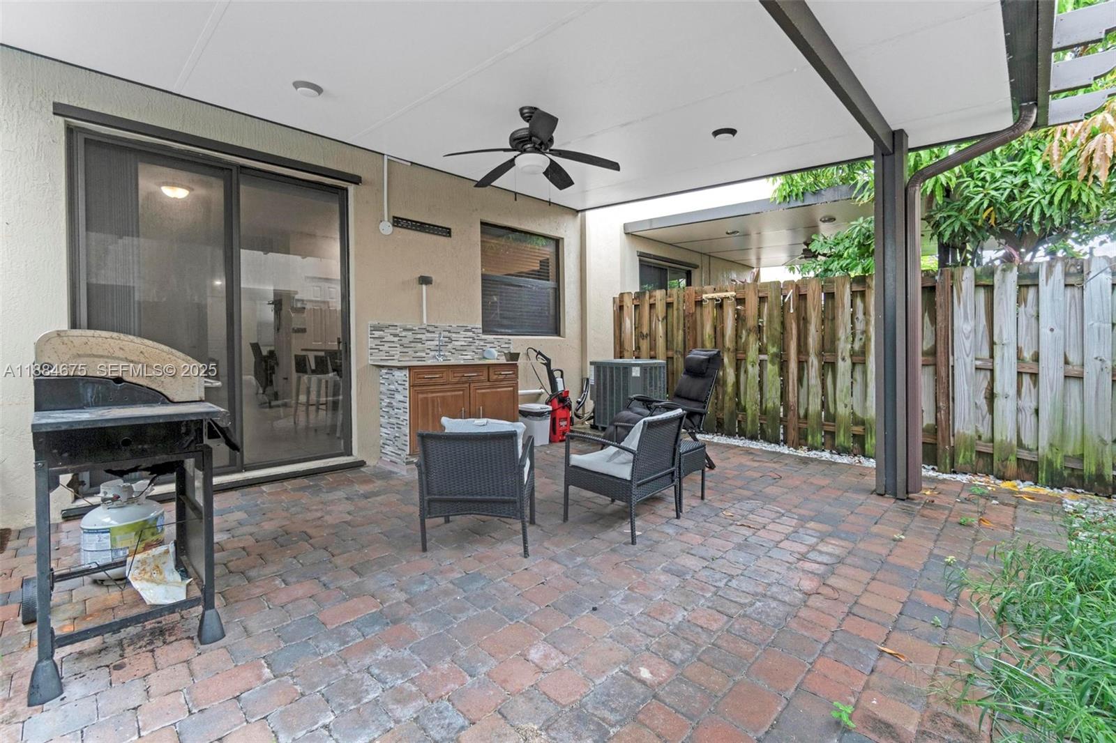 11413 Southwest 253rd Street, Unit 11413 Homestead, FL 33032 - Photo 27 of 44 a view of living room kitchen with furniture and outdoor shower
