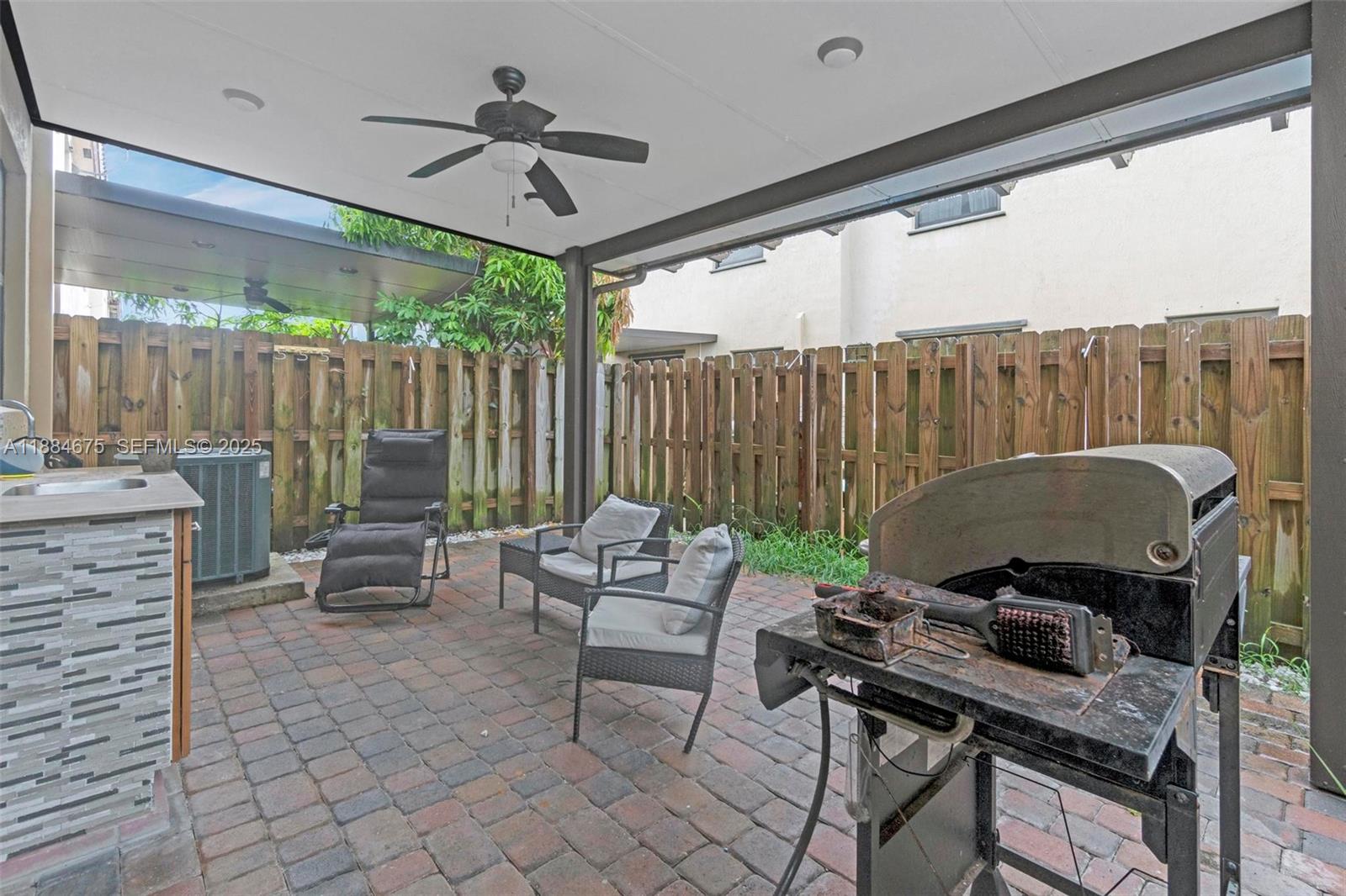 11413 Southwest 253rd Street, Unit 11413 Homestead, FL 33032 - Photo 30 of 44 a view of a patio with a table and chairs
