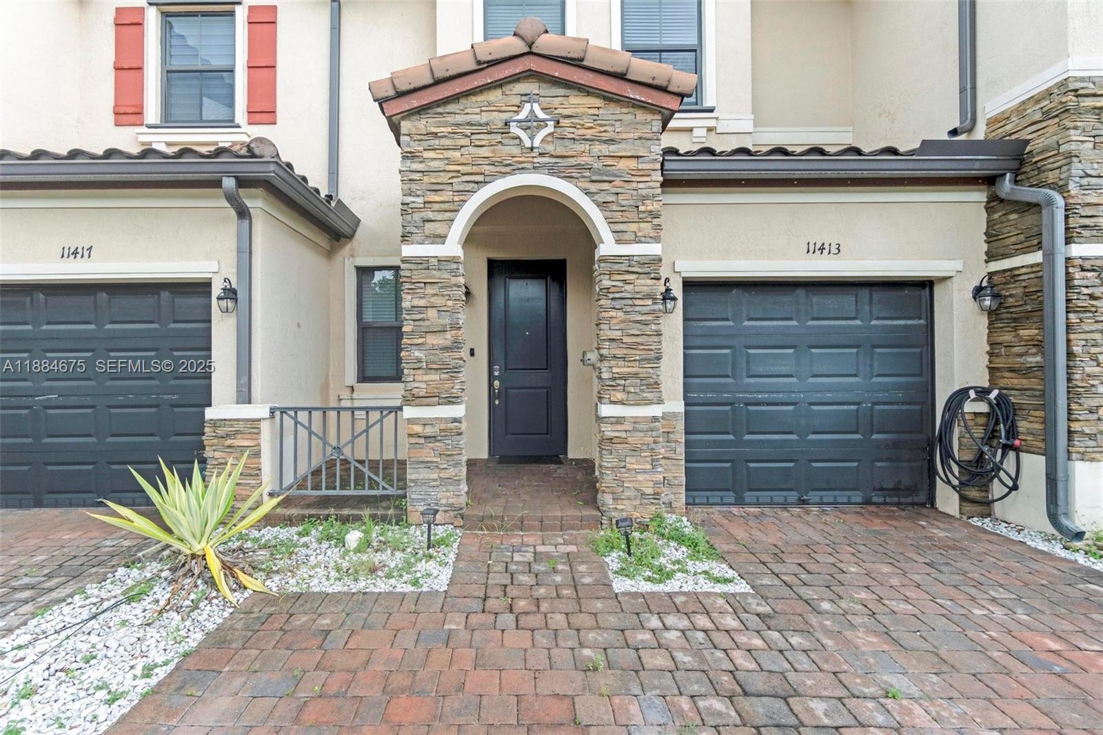 11413 Southwest 253rd Street, Unit 11413 Homestead, FL 33032 - Photo 5 of 44 a front view of a house with garden
