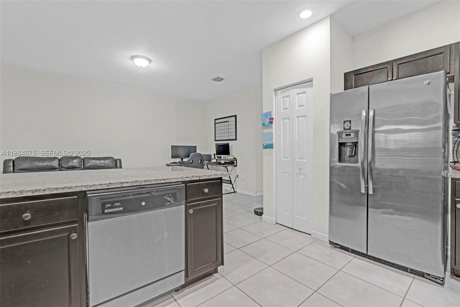 11413 Southwest 253rd Street, Unit 11413 Homestead, FL 33032 - Photo 9 of 44 a kitchen with stainless steel appliances a refrigerator and a sink