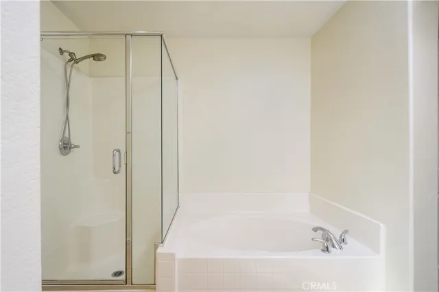 a bathroom with a bathtub and a shower