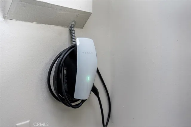 a view of a house with a large window and potted plants