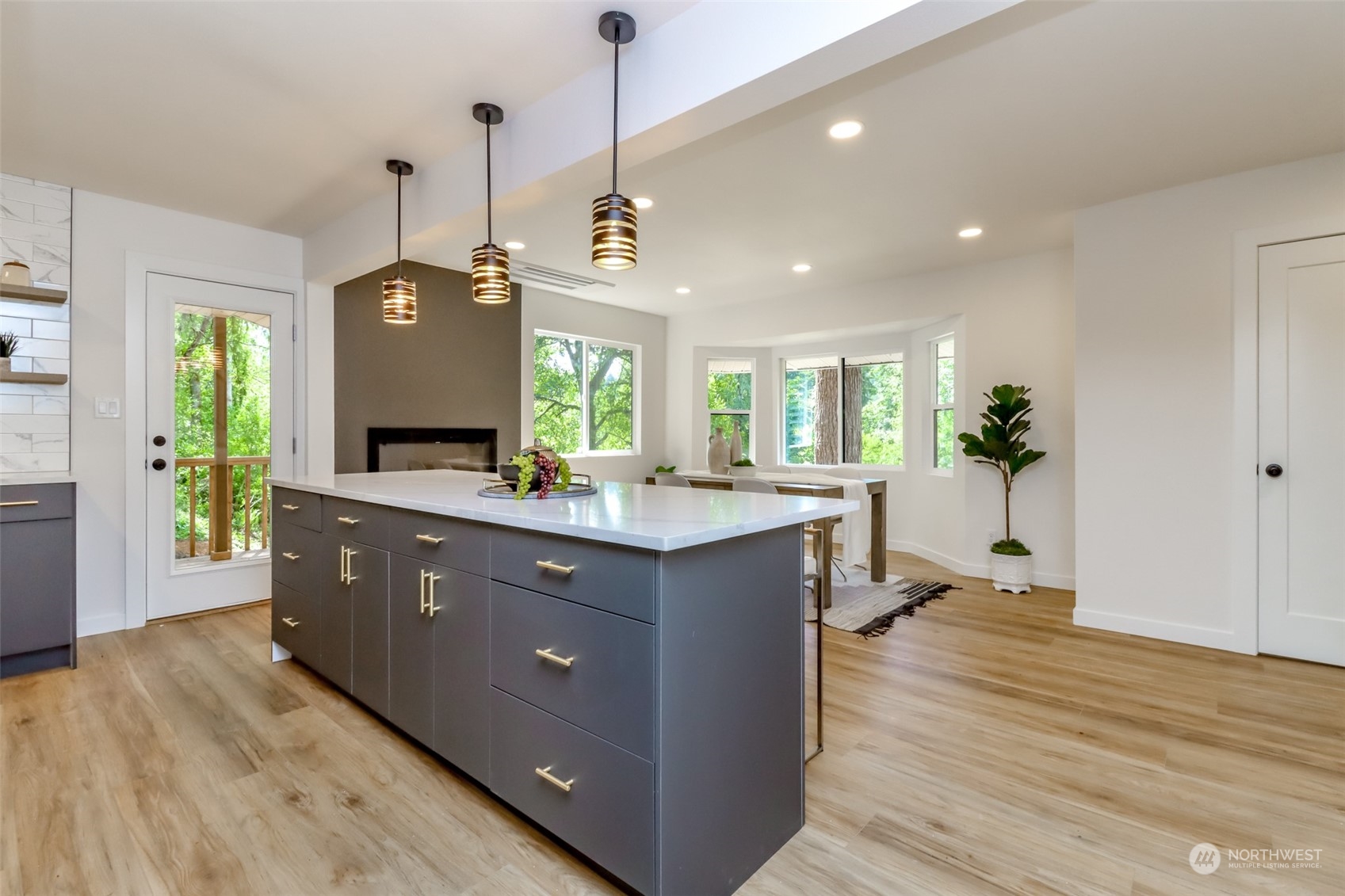 21220 Maxwell Road Southeast Maple Valley, WA 98038 - Photo 8 of 40 a kitchen with a refrigerator and a wooden floor