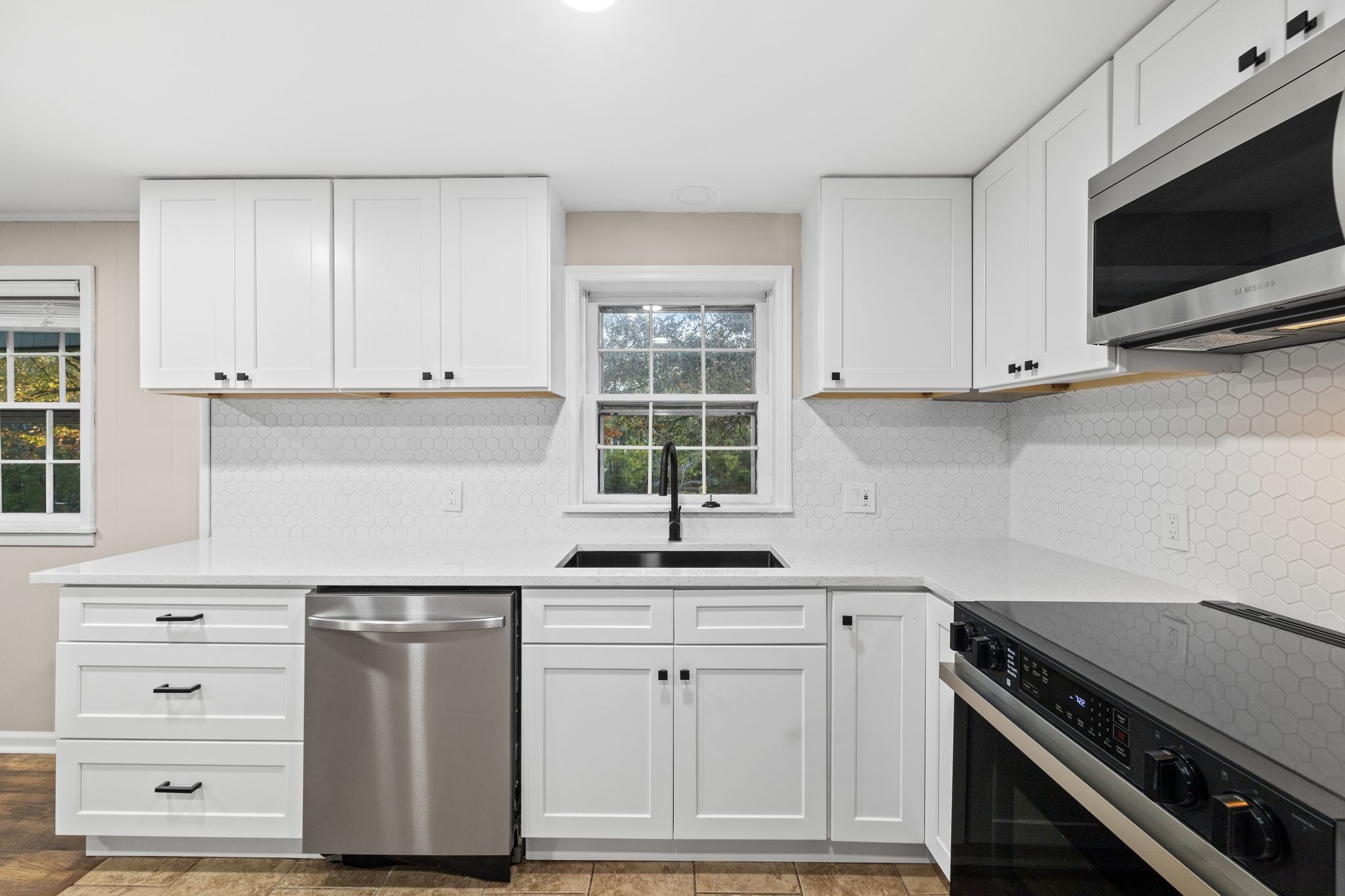 133 Mockerson Road Leoma, TN 38468 - Photo 13 of 33 a kitchen with granite countertop white cabinets and a stove with wooden floor
