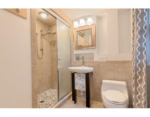 247 Sandy Pond Road Concord, MA 01773 - Photo 13 of 20 a bathroom with a sink toilet a mirror and shower